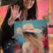 Tiffany Bohrer holding her original Coastal Cowgirl painting